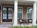 Inviting front porch with seating, decorative wreaths, and stylish columns at 2785 Disney Pl, Indian Land, SC 29707