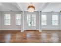 Bright living room boasting hardwood floors, white trim, french doors, and a stunning chandelier at 2785 Disney Pl, Indian Land, SC 29707