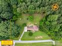 Aerial view showing property lines highlighting a home nestled on a lush green lot surrounded by mature trees at 310 Yarbro Rd, Kings Mountain, NC 28086