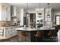 Elegant kitchen featuring white cabinets, stainless steel appliances, and a large island with seating at 3224 Ashwood Park Dr # 295, Belmont, NC 28012