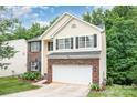 View of the home showcasing its brick and siding facade, two-car garage, and manicured lawn at 3236 Wicklow Ln, Clover, SC 29710