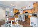 Open-concept kitchen featuring stainless steel appliances and a breakfast bar seating area at 3236 Wicklow Ln, Clover, SC 29710