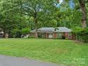Charming brick home with a manicured lawn and mature trees, creating a serene and inviting curb appeal at 3367 Tanglewood Dr, Rock Hill, SC 29732