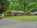 Charming brick home with a manicured lawn and mature trees, creating a serene and inviting curb appeal at 3367 Tanglewood Dr, Rock Hill, SC 29732