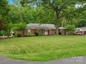 Charming brick home with a manicured lawn and mature trees, creating a serene and inviting curb appeal at 3367 Tanglewood Dr, Rock Hill, SC 29732