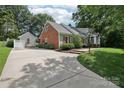 Spacious concrete driveway leading to a detached garage, complementing the home's exterior at 3916 Blowing Rock Way, Charlotte, NC 28210