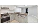 Bright kitchen with modern appliances, stone countertops, and ample cabinet space at 407 Cherry St, Belmont, NC 28012