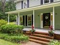 Inviting front porch with a swing and decorative plants leading up to the front door at 4848 Spicewood Dr, Charlotte, NC 28227