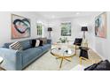 Bright living room with refinished hardwood floors, large windows, and modern decor at 4913 Seacroft Rd, Charlotte, NC 28210