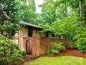 Enclosed courtyard with brick walls, wrought iron gate, and decorative landscaping, creating a private outdoor space at 5109 Goldcrest Dr, Indian Trail, NC 28079