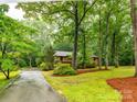 Scenic view of home and tree-lined driveway, enhancing the property's curb appeal at 5109 Goldcrest Dr, Indian Trail, NC 28079
