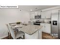 Modern kitchen with granite countertops, stainless steel appliances, and a convenient breakfast bar at 5137 Hyrule Dr, Charlotte, NC 28262
