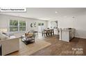 Inviting living space featuring a cozy seating area, contemporary decor, and natural light from a large window at 5137 Hyrule Dr, Charlotte, NC 28262