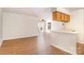 Bright living room with hardwood floors, white walls, and lots of natural light at 6203 Rosecroft Dr, Charlotte, NC 28215
