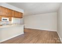 Inviting living room and kitchen area with hardwood floors at 6203 Rosecroft Dr, Charlotte, NC 28215
