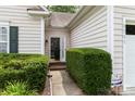 The front entrance is framed by lush greenery, offering a welcoming appeal at 6303 Trevor Simpson Dr, Indian Trail, NC 28079