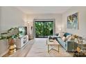 A cozy living room features a modern couch, stylish decor, and access to a balcony at 715 N Church St # 310, Charlotte, NC 28202