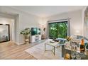 Inviting living room featuring a balcony view, contemporary furnishings, and wood-look flooring at 715 N Church St # 310, Charlotte, NC 28202