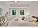 A serene main bedroom showcases light-filled windows, soft textures, and a neutral palette at 715 N Church St # 310, Charlotte, NC 28202