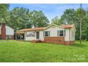 Single-story home featuring brick accents, light siding, and a well-kept front lawn at 798 Wilson St, China Grove, NC 28023