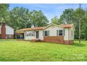 Single-story home featuring brick accents, light siding, and a well-kept front lawn at 798 Wilson St, China Grove, NC 28023