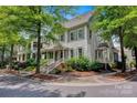 Beautiful two-story home on a corner lot with a cozy porch, manicured landscaping, and mature trees at 104 Edgewater Park St, Davidson, NC 28036