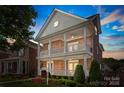 Charming brick home featuring a double front porch, manicured landscaping, and a welcoming facade at 108 Forrester Ave, Belmont, NC 28012