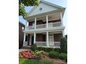 Stately brick home featuring double porches with white railings, offering charming curb appeal and classic design at 108 Forrester Ave, Belmont, NC 28012