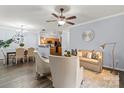 Open living space with dark hardwood floors, neutral furniture, and partial view into kitchen area at 11911 Ridgeway Park Dr, Charlotte, NC 28277