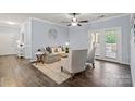 Cozy living room with neutral furniture, modern ceiling fan, and view to the front door at 11911 Ridgeway Park Dr, Charlotte, NC 28277