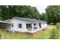 Charming one-story home featuring a spacious porch with outdoor seating and a classic white facade at 1197 Fincher Rd, Fort Lawn, SC 29714