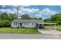Charming single-story home with a well-manicured lawn and a covered carport at 1266 18Th Ne St, Hickory, NC 28601