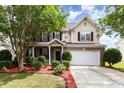 Charming two-story home featuring manicured landscaping and a two-car garage at 13305 Mallard Landing Rd, Charlotte, NC 28278