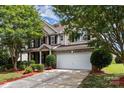 Charming two-story home featuring manicured landscaping and a two-car garage at 13305 Mallard Landing Rd, Charlotte, NC 28278