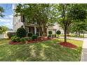 Well-maintained home with lush green lawn, mature trees, and tasteful landscaping at 13305 Mallard Landing Rd, Charlotte, NC 28278