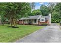 Attractive single-story home with a lush green lawn and long driveway at 1344 Shannonhouse Dr, Charlotte, NC 28215