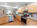 Modern kitchen with stainless steel appliances, sleek cabinets, and hardwood flooring at 1344 Shannonhouse Dr, Charlotte, NC 28215