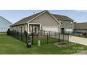 Fenced backyard with a covered patio and well-maintained lawn at 148 Kerri Dawn Ln, Locust, NC 28097