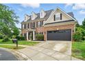 Charming two-story brick home with an attached two-car garage and well-maintained landscaping at 1522 Napa Nw St # 1240, Concord, NC 28027