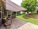 Cozy covered back patio with brick pavers, perfect for outdoor seating and relaxation with a retractable awning at 200 Sweet Briar Dr, Fort Mill, SC 29707