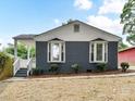Home exterior showing gray brick finish and nicely landscaped front yard at 2017 Brewton Dr, Charlotte, NC 28206