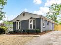 View of the home with freshly painted brick, nice trim, and updated landscaping at 2017 Brewton Dr, Charlotte, NC 28206