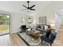 Bright living room featuring hardwood floors, a modern ceiling fan, and stylish decor at 2017 Brewton Dr, Charlotte, NC 28206