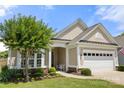 Well-maintained single-story home featuring manicured landscaping, an attached two car garage, and welcoming entryway at 2066 Vermount Way, Indian Land, SC 29707