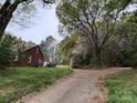 Charming brick home with a driveway and mature trees, including a beautiful wisteria at 2096 S Point Rd, Belmont, NC 28012