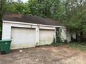 Detached two-car garage with weathered doors and climbing ivy, adding rustic charm at 2096 S Point Rd, Belmont, NC 28012