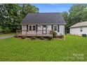 Charming home featuring a well-kept lawn and a cozy front porch, perfect for enjoying the outdoors at 2146 Marwood Ln, Albemarle, NC 28001