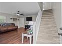 Bright living room with wood flooring, a staircase, and neutral walls at 2146 Marwood Ln, Albemarle, NC 28001