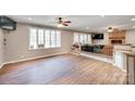 Spacious living room with large windows, wood floors, and a cozy brick fireplace at 257 Amity Dr, York, SC 29745