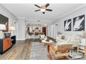 Bright living room flows into the kitchen, featuring hardwood floors and modern decor at 300 W 5Th St # 003, Charlotte, NC 28202